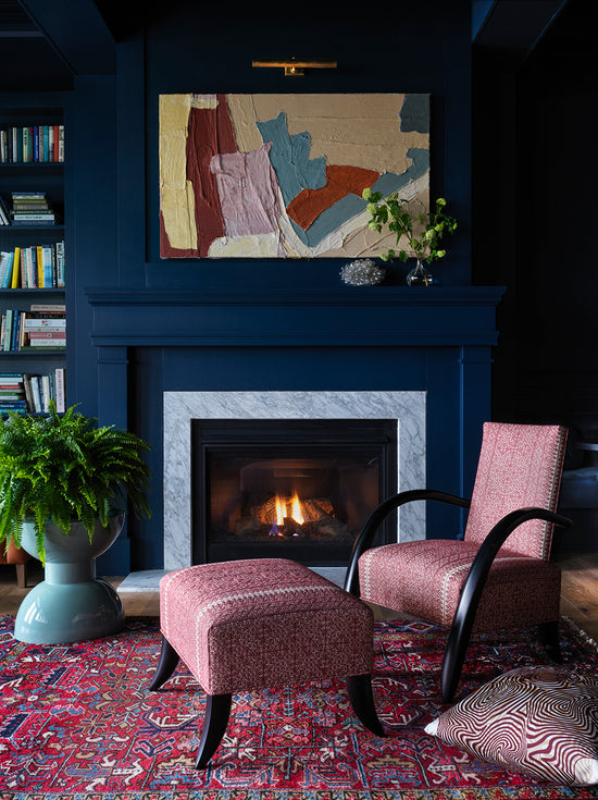 Fireplace with chairs in front of it