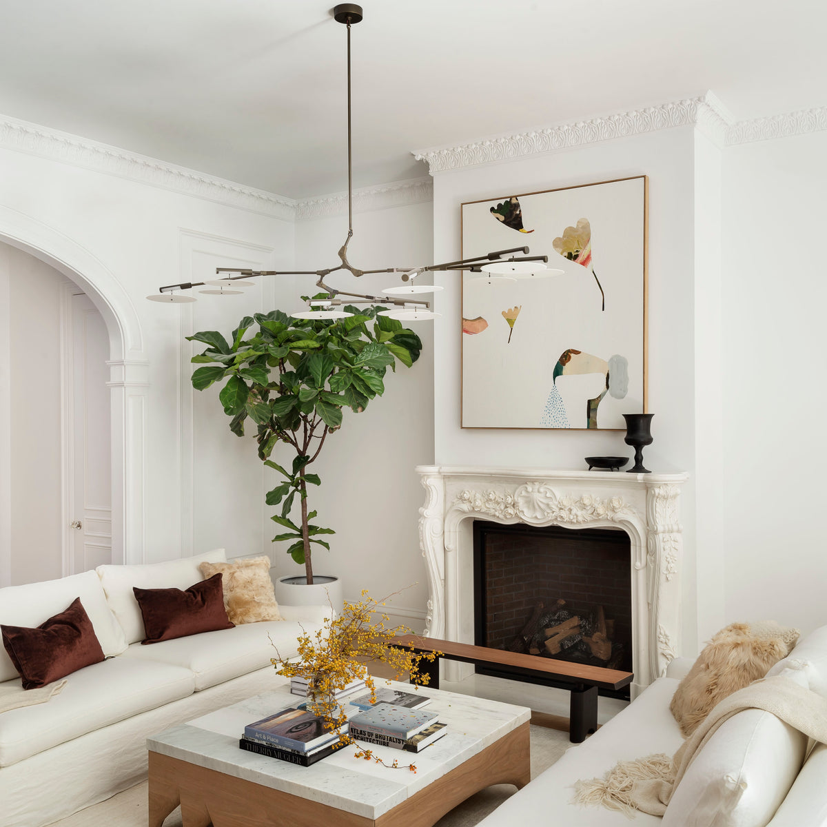 Living room with white sofa, modern walnut finished coffee table, and decorative elements.
