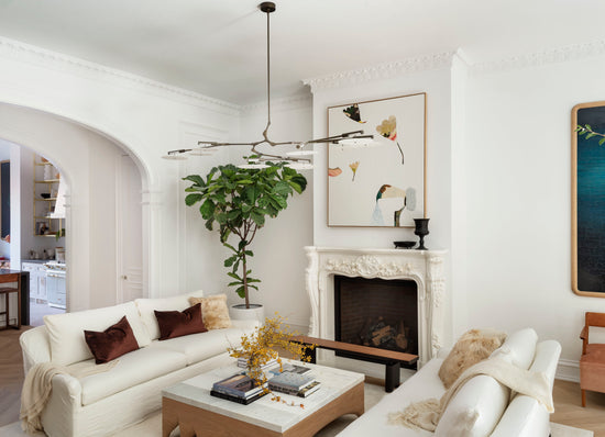 Living room with white sofa, modern walnut finished coffee table, and decorative elements.
