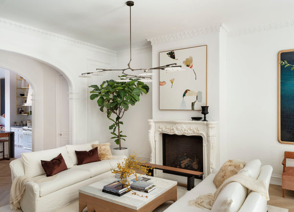 Living room with white sofa, modern walnut finished coffee table, and decorative elements.

