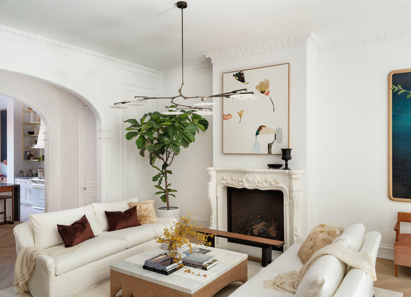 Living room with white sofa, modern walnut finished coffee table, and decorative elements.
