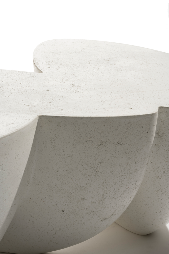  Close-up of a white concrete stool with a smooth surface.
