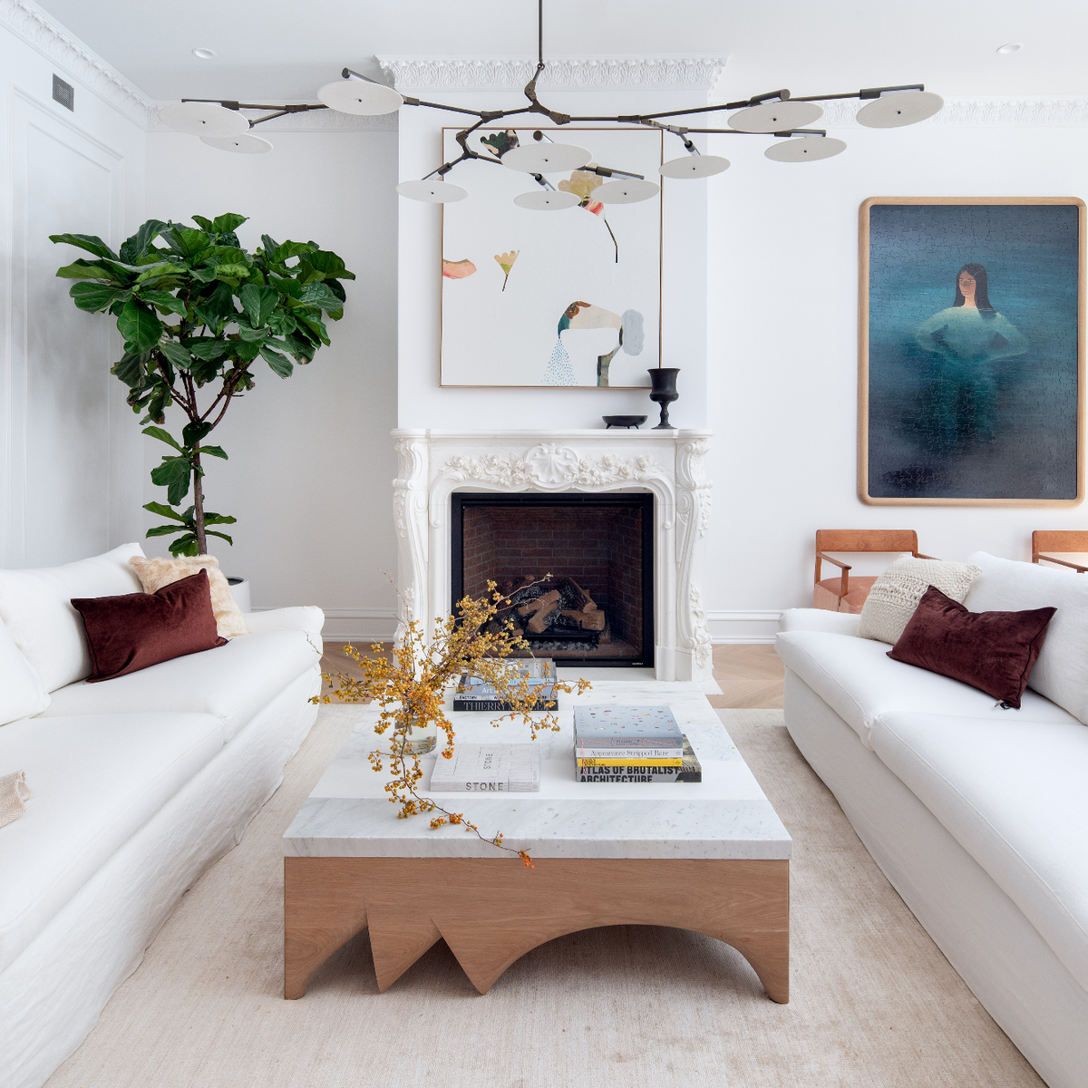 Modern living room with white sofas, a Modern white oak table, and decorative elements.
