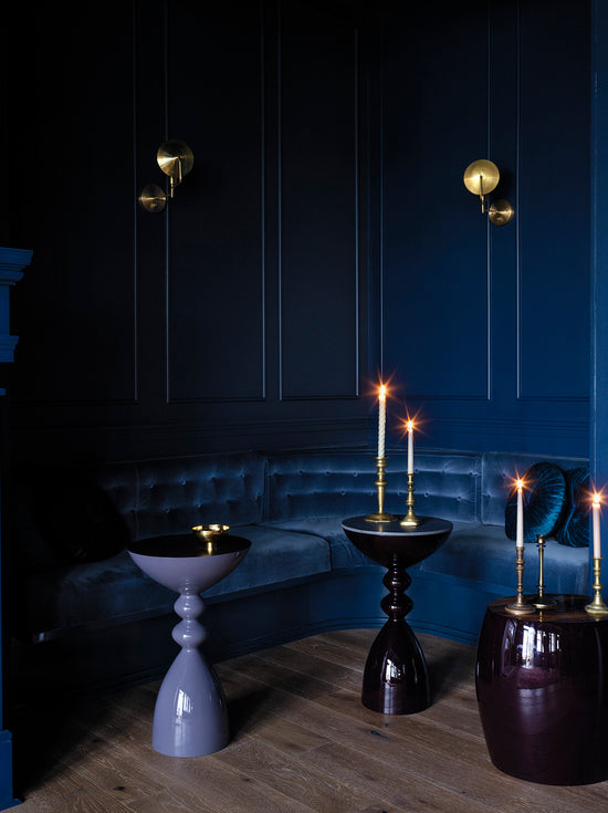 Candles on various High Gloss Lacquer Finish Legacy collection side tables in front of a couch 