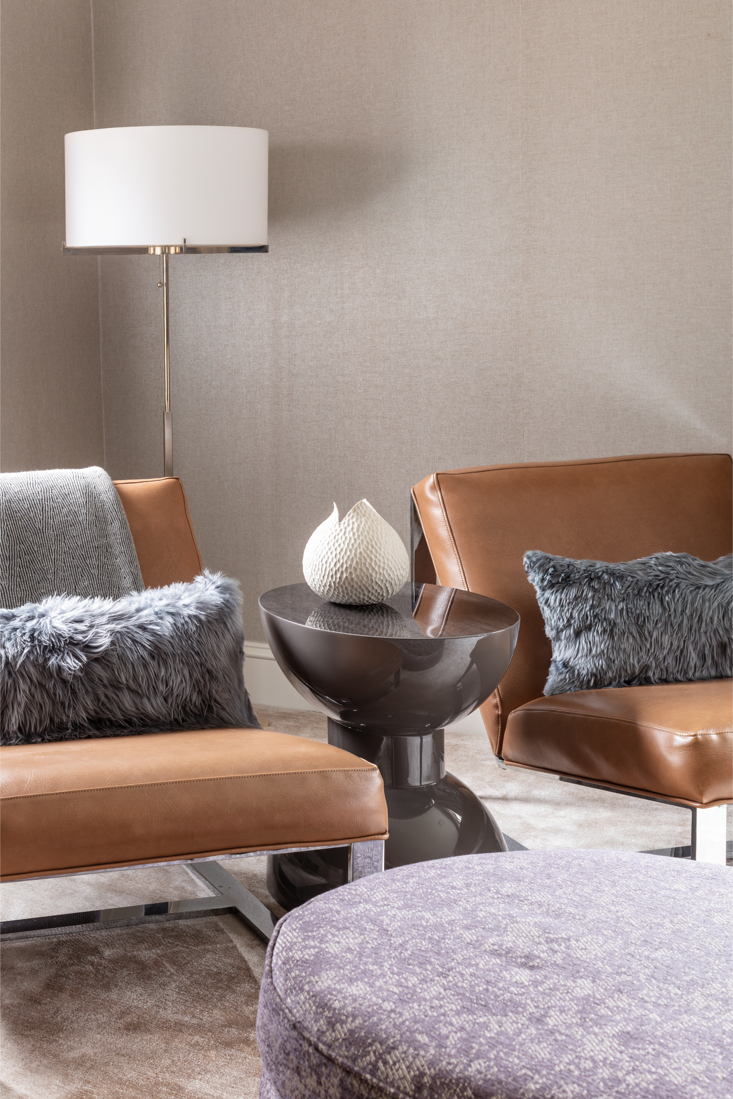 Modern living room with brown leather chairs,Modern Charcoal high gloss lacquer finish Morocco side table, and decorative lamp